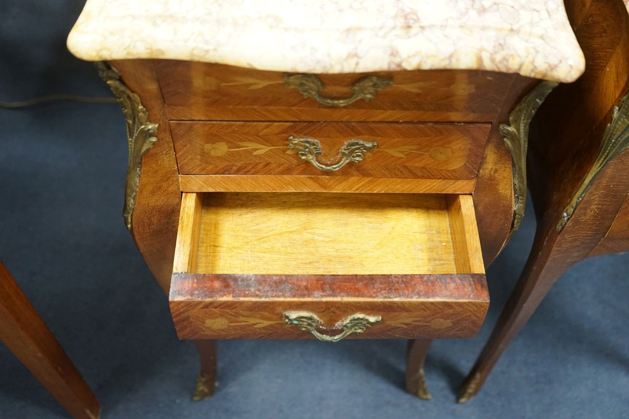 A pair of Louis XVI design marquetry inlaid, gilt metal mounted serpentine bedside chests, width 34cm, depth 29cm, height 73cm